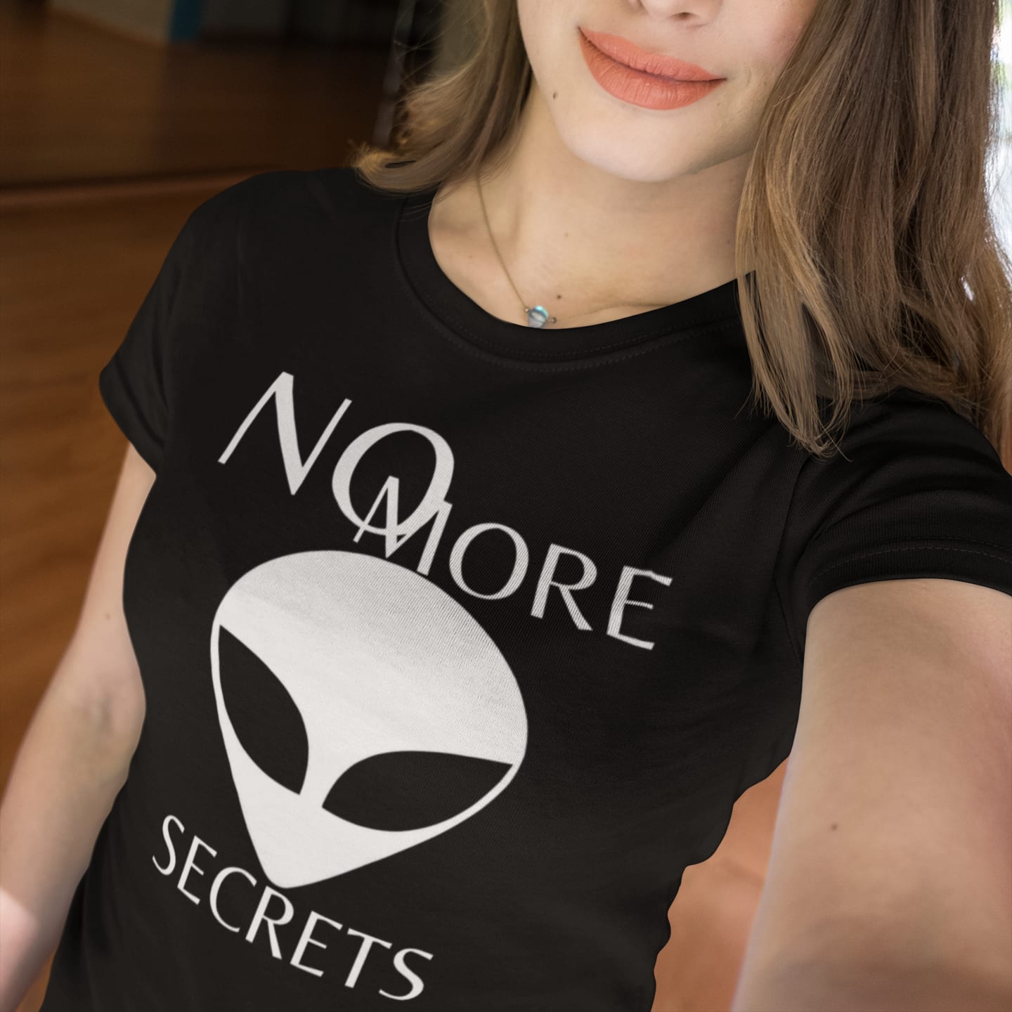 Model wearing the No More Secrets White Alien Face black T-shirt (front view)