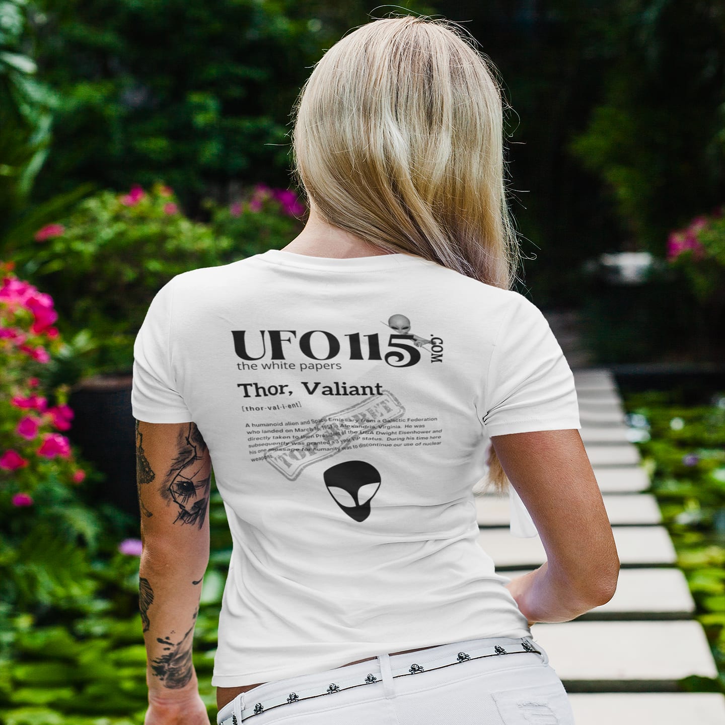 Model wearing the The White Papers Valiant Thor white T-shirt (back view, UFO115 back print)